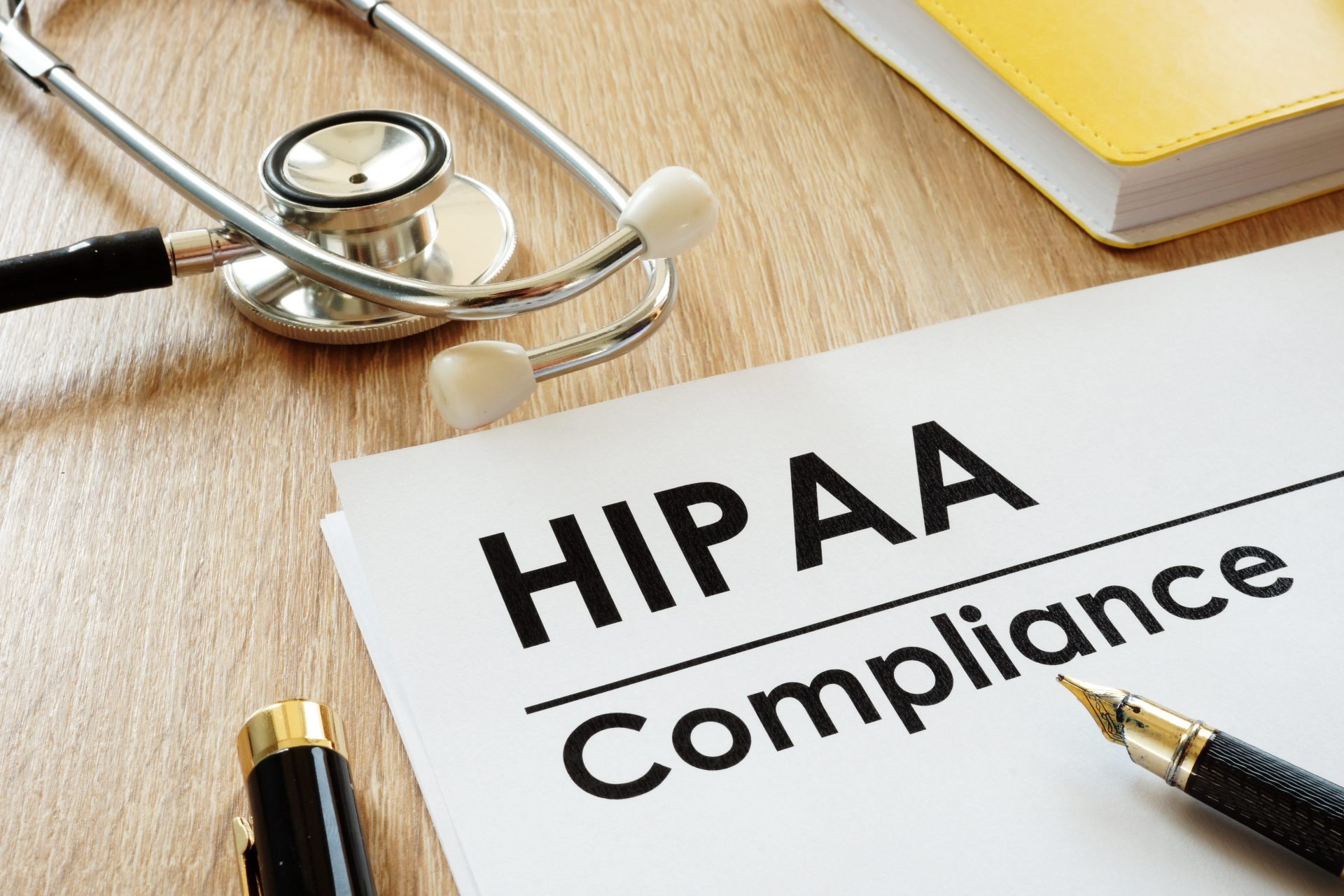 HIPAA Compliance application and stethoscope on a desk