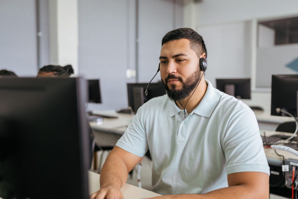 Man working on headset at computer